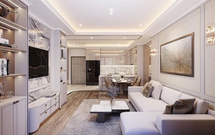 Phối cảnh phòng khách Neoclassic sàn gỗ, kệ TV ốp đá vân xám kèm kệ sách có đèn, sofa chữ L kem thông sang bếp và bàn ăn