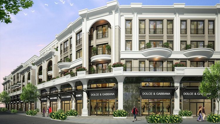 Phối cảnh dãy Golden Shophouse Vạn Phúc City với tầng trệt cửa kính vòm có biển hiệu thương hiệu, ban công cong và cây xanh dọc vỉa hè